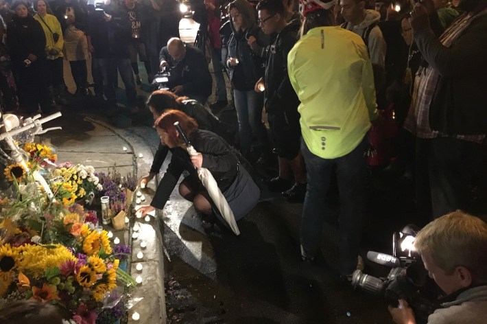 Mourners place candles at Anastasia's ghost bike