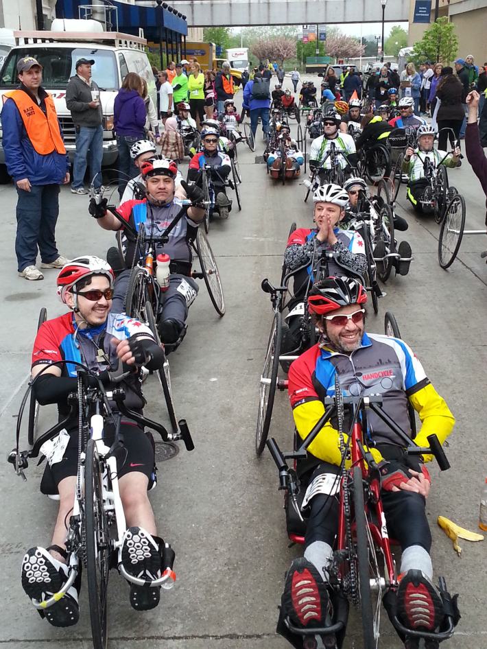 Handcycle Chicago team members Mike Knaap (front right), Jose Alejandre (front left), Adon Sandoval (back left), and Mirel Pantus (back right), at a race. Click to enlarge. Photo: Trisha Daniels.