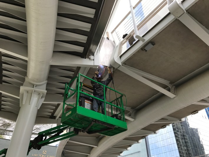 A worker welds the underside of the flyover. Photo: John Greenfield