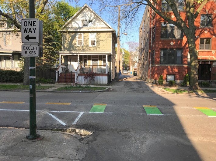 Signs and green paint alert drivers leaving alleys to the presence of contraflow bike traffic. Photo: John Greenfield