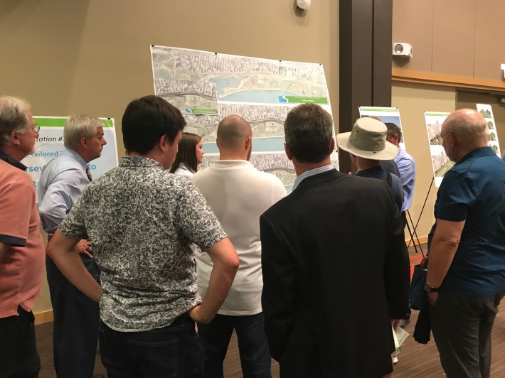 Residents check out renderings at the meeting. Photo: Charles Papanek