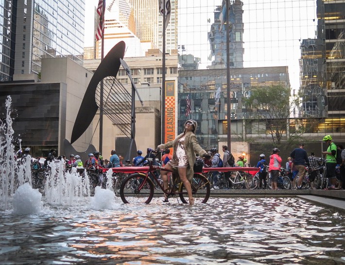 Masser "Womyn Wonder" takes a dip in a fountain as the anniversary ride assembles at Daley Plaza. Photo: Miloš Otić