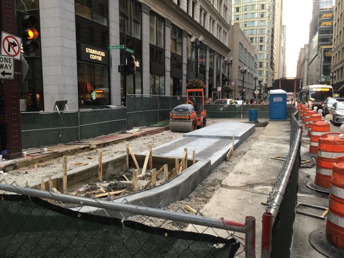 Looking west on Washington west of Wabash -- a new island is being built to shelter cyclists and shorten pedestrian crossing distances. Photo: CDOT