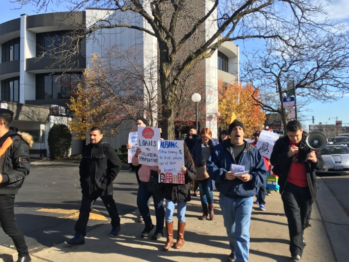 Residents and activists march to Albany Bank. Photo: Lynda Lopez