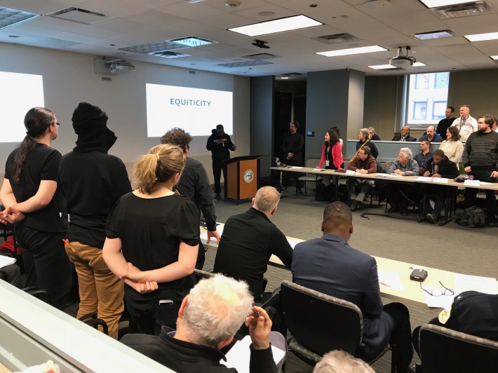 MBAC attendees stand up to show support for Equiticity's campaign to end racially biased bike ticketing. Photo: John Greenfield