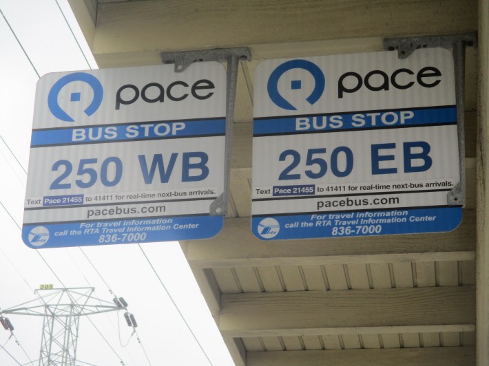 While some Pace bus stop signs - like these signs at Dempster-Skokie Yellow Line 'L' station Park-and-Ridge - include bus tracker information, most don't. Photo: Igor Studenkov