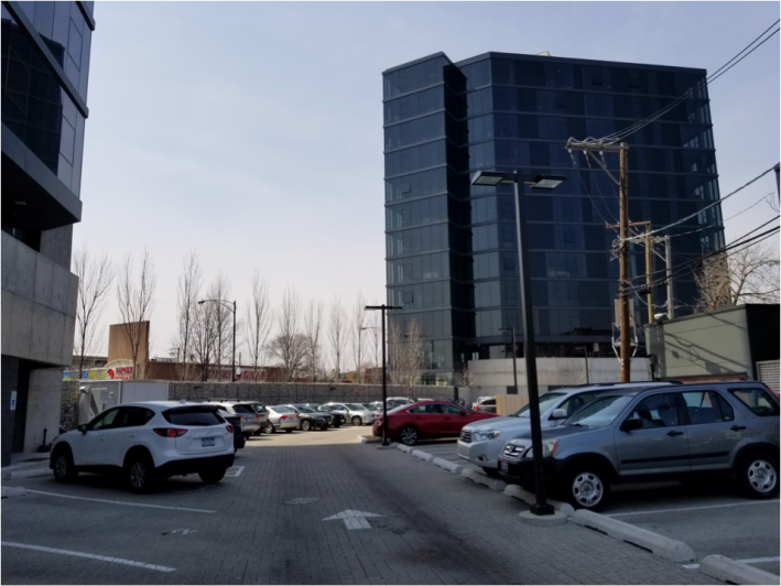 Photo: 59 surface parking spots behind the towers. Photo: Borna Khoshand