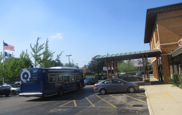 For seniors and people with disabilities, one of the advantages of the Niles Free Bus is that it pulls up closer to major destinations. While Route 226 stops on nearby Oakton Street, Route 410 of the Niles Free Bus pulls right up to the Niles library entrance. Photo: Igor Studenkov