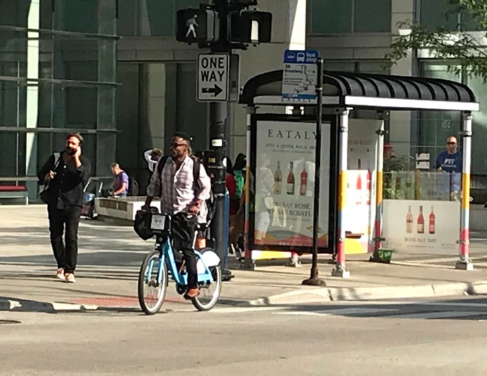 A man rides a Divvy in River North, where a Black bike advocate claims police have been racial profiling Divvy users. Photo: John Greenfield