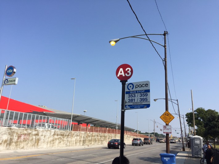 The temporary stop for the Pace Route 381 bus is located far from the station entrance near the stoplight. Photo: Anne Alt