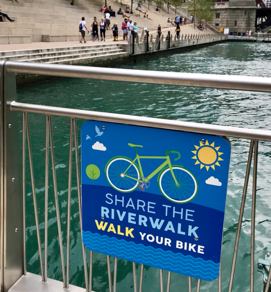 Ignore Those New Signs It's Legal to Bike on the Riverwalk
