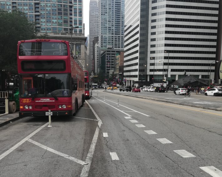 Looking east, tour buses block the curbside bike lane on Upper Randolph. A second bike lane, to the right, leads to new bike lanes on Middle Randolph.