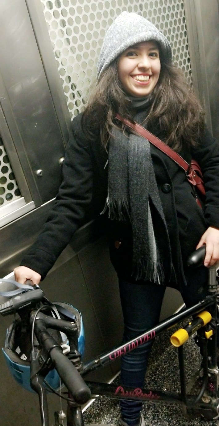 Lynda riding a CTA elevator during a winter bike-and-ride trip.