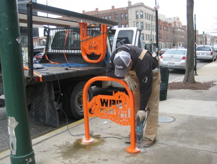 Installing a branded rack ion Ashland Avenue in Wicker Park. Photo: SSA #33