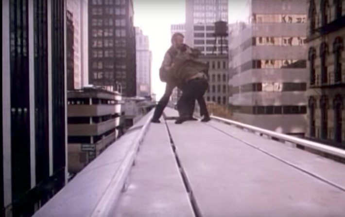Chuck Norris beats up a bad guy on top of the Brown Line in "Code of Silence."