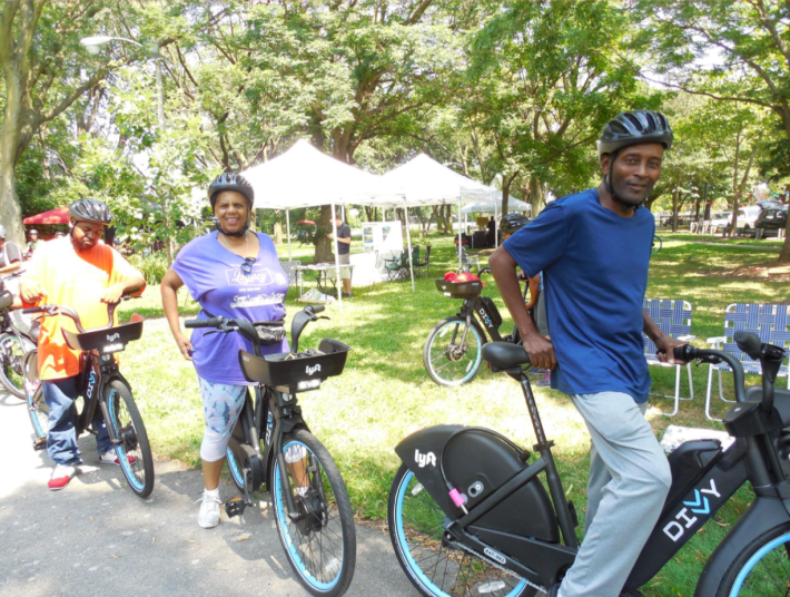 Test-riding e-Divvys at a community event. Photo: CDOT