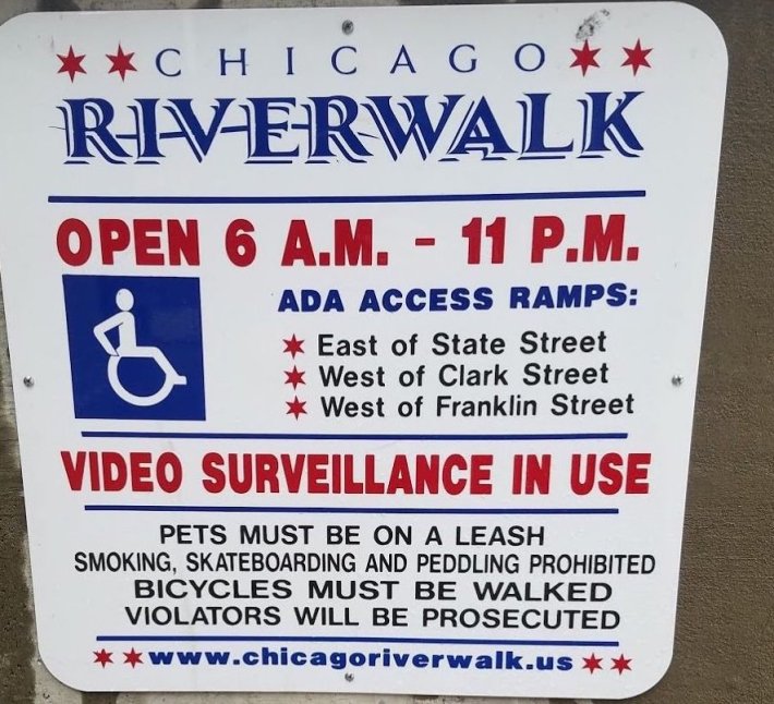 One of the signs at the riverwalk entrances making a bogus threat that bike riders will be prosecuted. Photo: John Greenfield