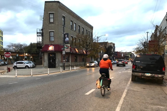 A cyclist rides in one of the new dashed bike lanes on Milwaukee. Photo: John Greenfield