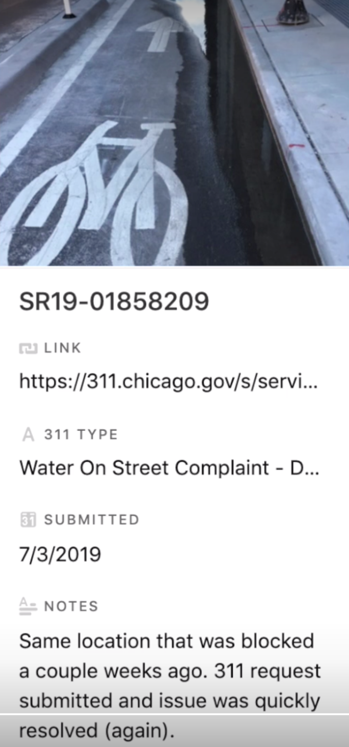 Screenshot of a 311 request about standing water in protected bike lane in the South Loop. Image via Bike LAne Uprising