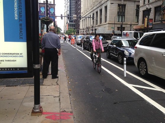 Chicago parking-protected bike lanes include a striped buffer, usually with plastic posts, to help keep cyclists away from opening car doors. Photo: John Greenfield