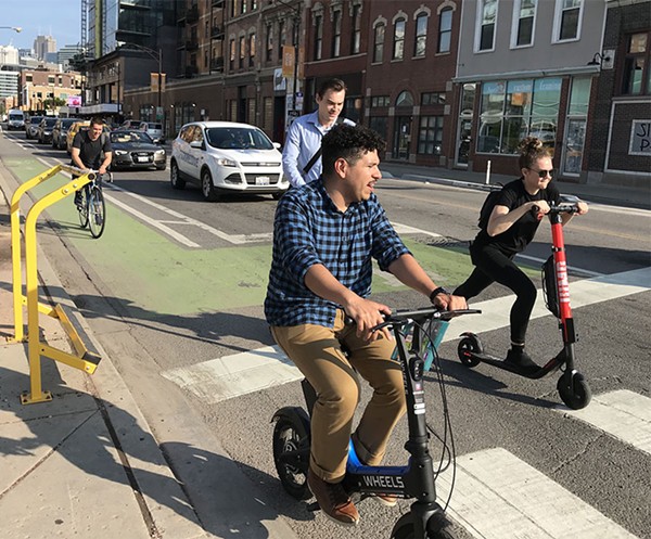 Seated scooters give the rider a lower center of gravity and generally have larger wheels than standing scooters, and therefore may be safer on city streets. Photo: John Greenfield