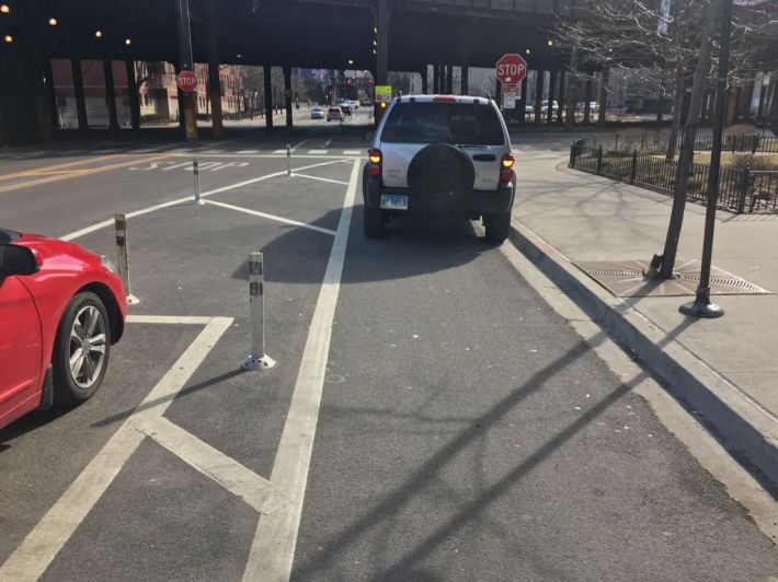 An illegally parked SUV blocks the Kinzie Street protected bike lane. Photo: Steven Vance