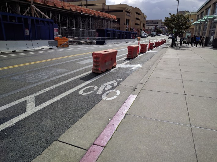 Jersey barriers placed along a bike lane in Oakland, California to prevent illegal parking. Photo: Roger Rudick, Streetsblog San Francisco