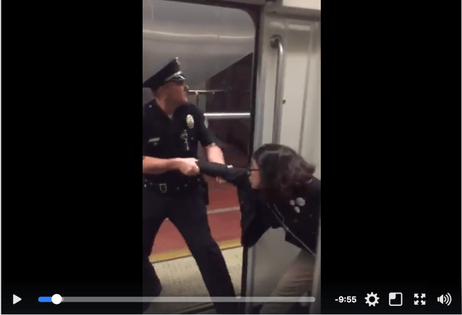 An officer drags a teen off an LA Metro train for not removing her foot from a seat. Image: Brock Bryan
