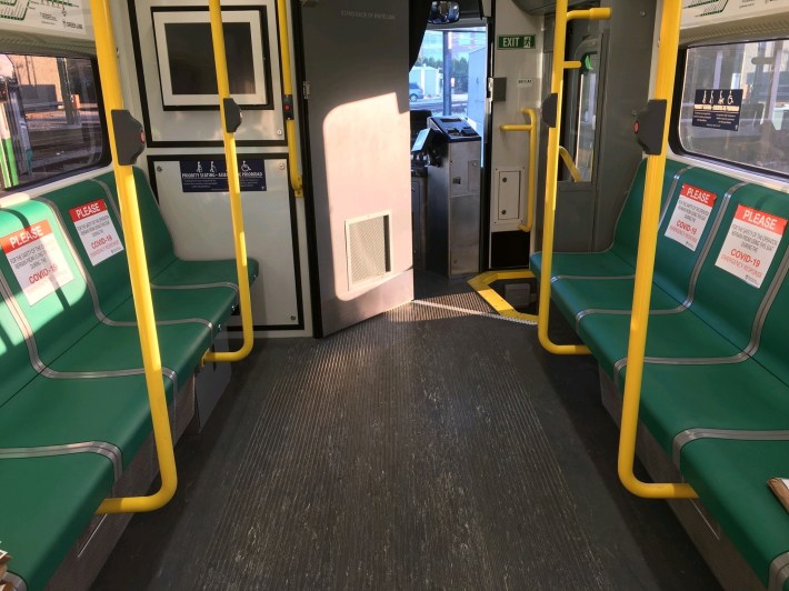 A Boston T car with seats marked with signs encouraging social distancing. Photo: MBTA