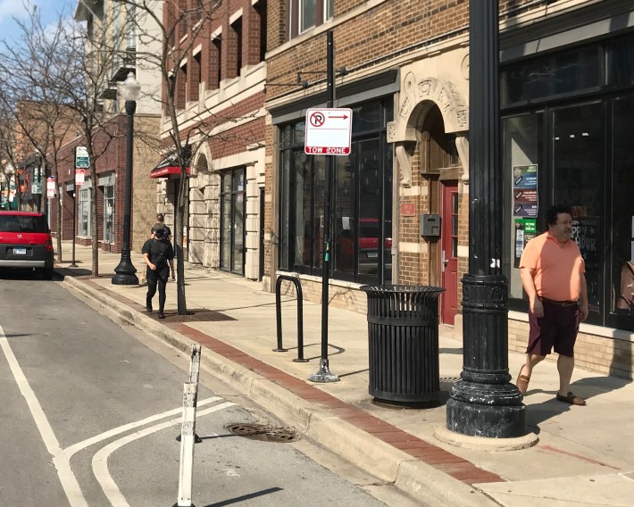 Walkijng along the curb to stay out of the way of other pedestrians on Clark near Carmen Avenue. Photo: John Greenfield