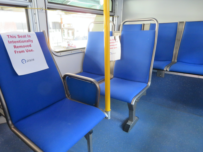 Signs posted on Pace bus seats to encourage social distancing. Photo: Jeff Zoline