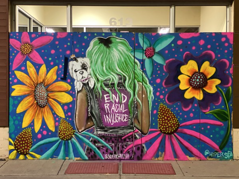 The façade of a Petco in the South Loop. Image: Barrett Keithley/Chicago Reader, art by Squeak Starzulaand and Mario Mena
