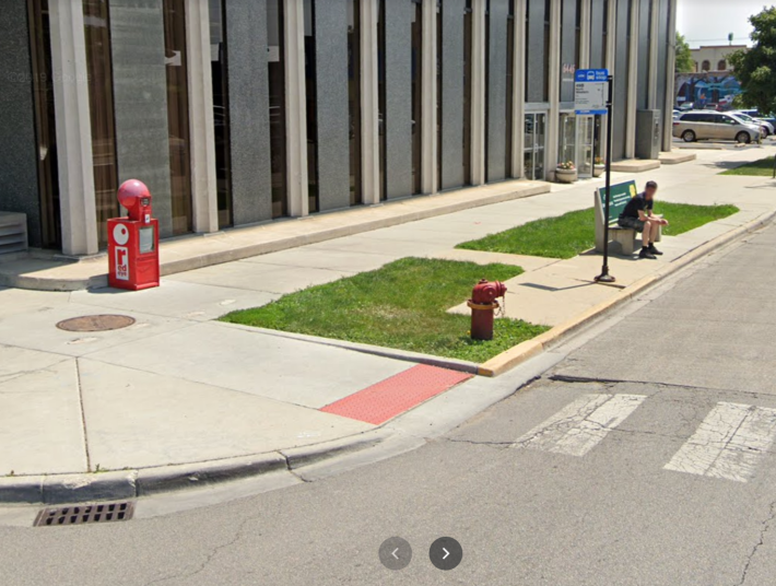 July 2019 Google Street View image of the southeast corner of Devon and Arthur avenues by the bank, showing a CTA bus pad sticking out above the road.