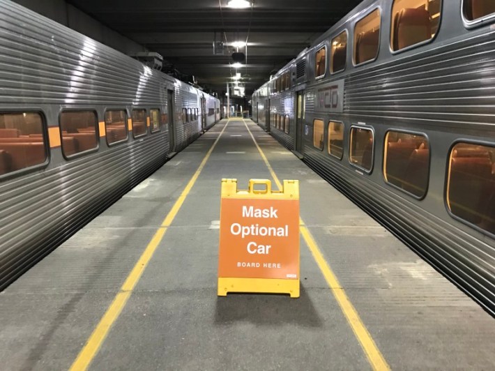 A sandwich board at the South Shore Line's Millennium Park station for the Mask Optional Car. Photo: John Greenfield