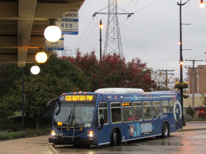 Route 626 bus at Dempster-Skokie Yellow Line station, with the sign for the suspended Route 620 bus in the foreground. Photo: Igor Studenkov