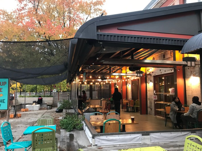 This whole area of Colectivo Coffee on Clark Street in Lincoln Park was previously a parking lot, but now it's a heated, mostly open covered patio, and there's also a small fire pit. Photo: John Greenfield