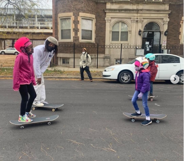 Katan Blackburn with youth during a skateboarding lesson near the 51st Green Line stop.Photo: Kahari Blackburn