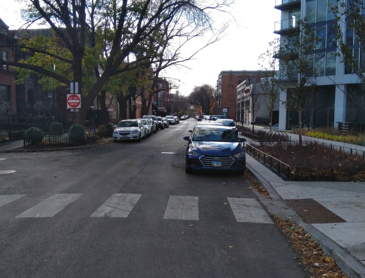 Orchard Street, looking south. A driver is parked against the bump-out, making it difficult for other motorists to see a person stepping off the curb.