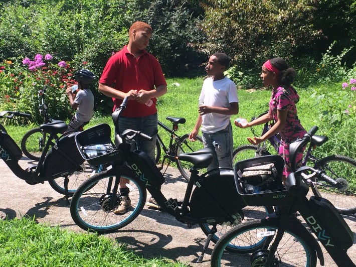 Youth check out the new Divvy bikes at a community event in Riverdale in 2019. Photo: James Porter