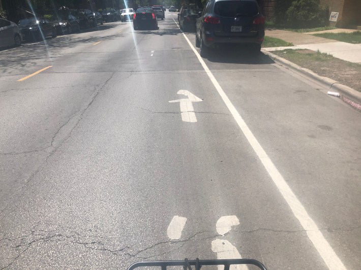 Another photo of faded "advisory lanes" along N Damen Avenue.