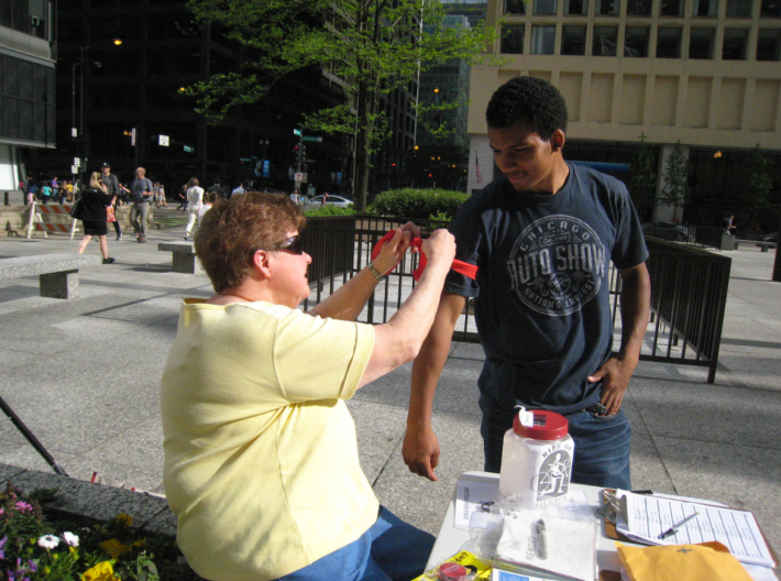 A participant who was injured on his bike gets a red armband at a Ride of Silence event in Chicago's Daley Plaza. Photo: Chicago Ride of Silence