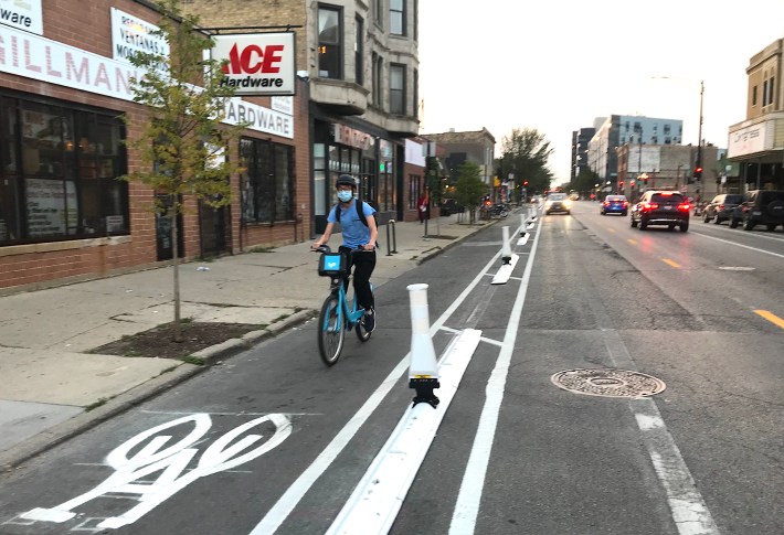 Parking was stripped from one side of Milwaukee Avenue to accommodate protected bike lanes. Photo: John Greenfield
