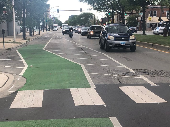 Looking South from a Northbound "bike lane" along Clark St. at near Granville. Driving lanes reduce from two to one with very little notice for drivers. A sign alerting drivers of a lane reduction would be helpful.