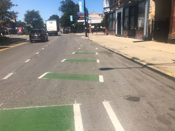 Dashed green and white lines possibly meant to indicate an advisory bike lane on Clark St. as you approach Rosemont. A couple feet North the space near the curb is meant to be a plastic post protected bike lane.Photo: Courtney Cobbs