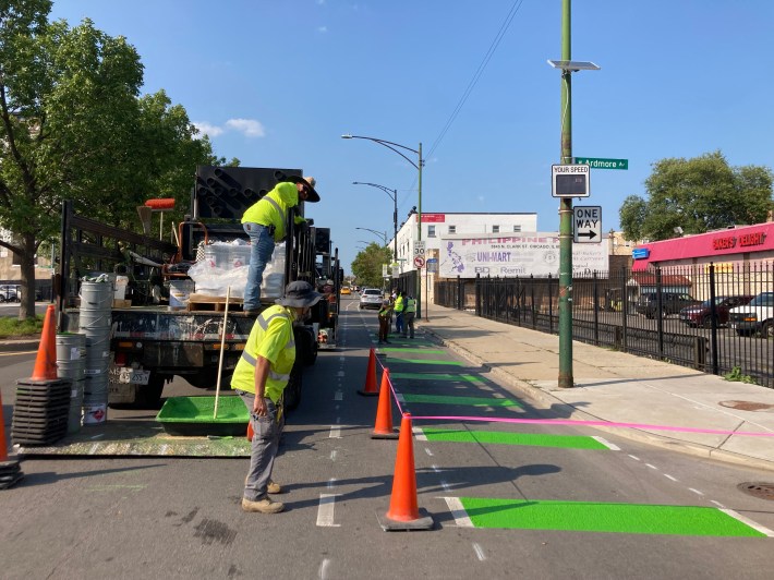 A crew applying green paint to the Clark bike lanes today. Photo: John Greenfield