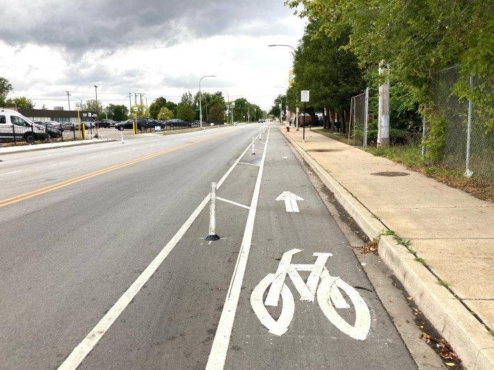 New bike lanes delineated with flexible plastic posts on 119th Street. Installing concrete curbs instead would have provided a physical barrier to prevent drivers from striking cyclists. Photo: John Greenfield