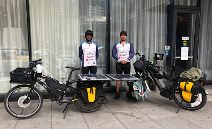 Reddy and Fourzan outside of a downtown Chicago hotel with their e-bikes. Photo: Courtney Cobbs