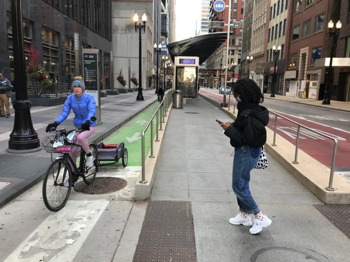 Bus stop island with protected bike lane on Washington Street in the Loop. The Clark Street