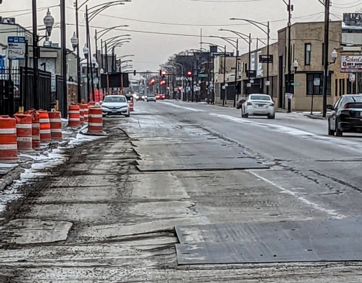 Steel road plates on Grand Avenue in West Town. Photo: Ruth Rosas