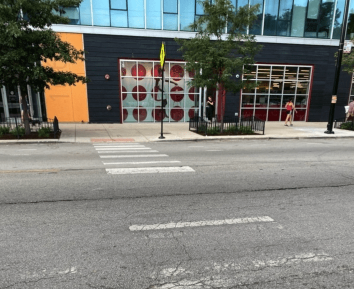 Faded crosswalk on Division at Paulina, connecting a Target with a Starbuck's. Photo via 1st Ward